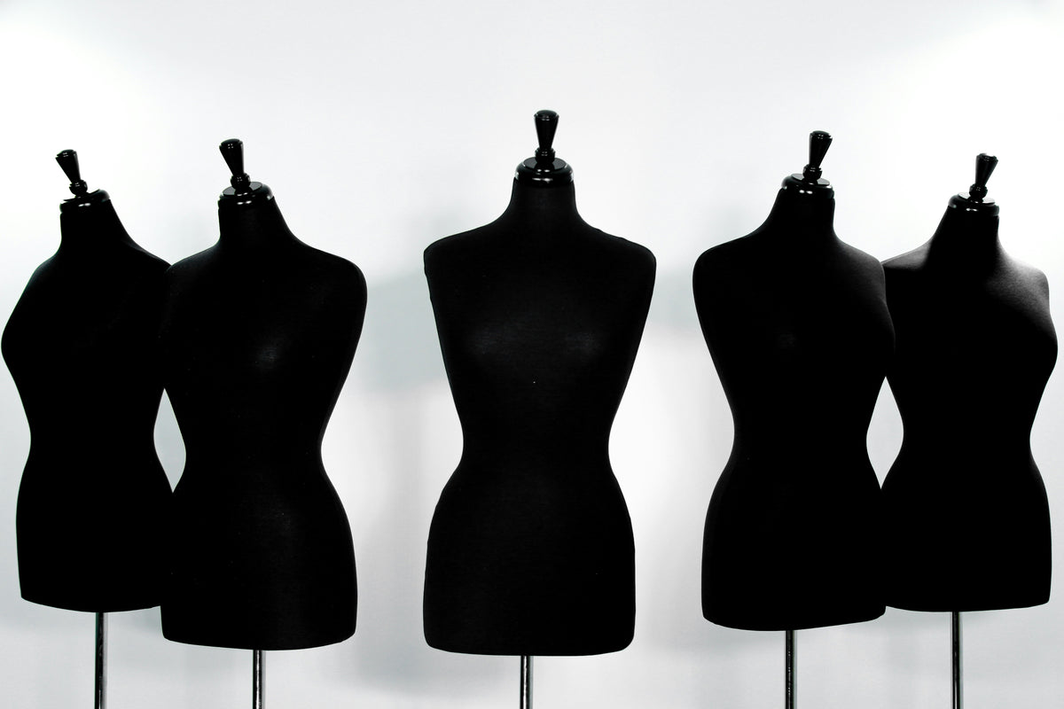 Silhouettes of mannequins against a white background