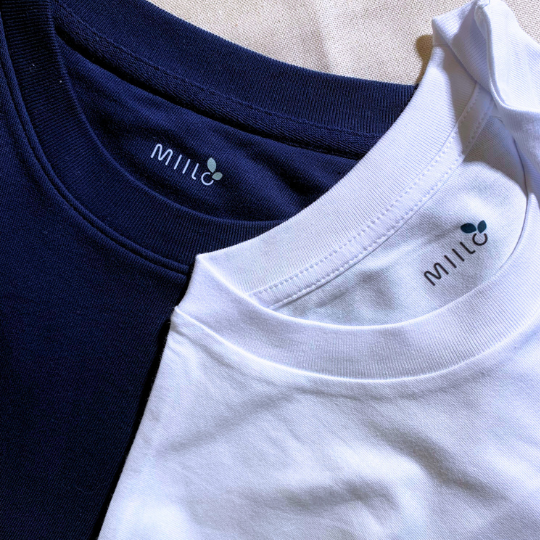 a white and a navy blue crew neck short sleeves tshirts with Miilo's brand on the collar